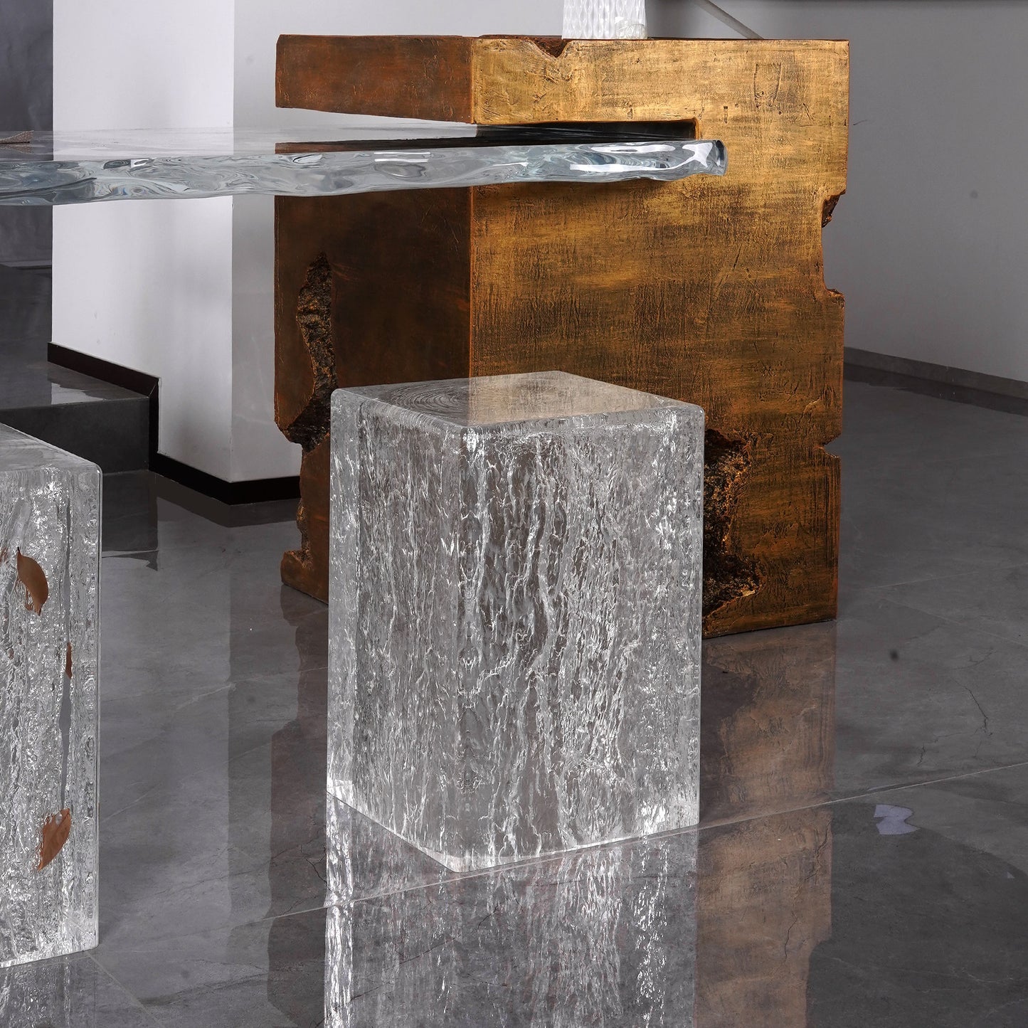 Rectangular stools with clear textured design sitting in a minimalistic setting with a bronze japandi furniture behind. Accent chair decor placing beside a table used as a stool.